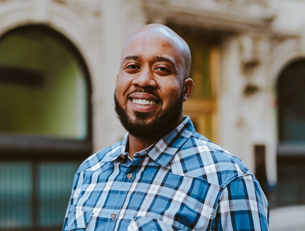 Associate Sales Manager Tyler smiles at the camera